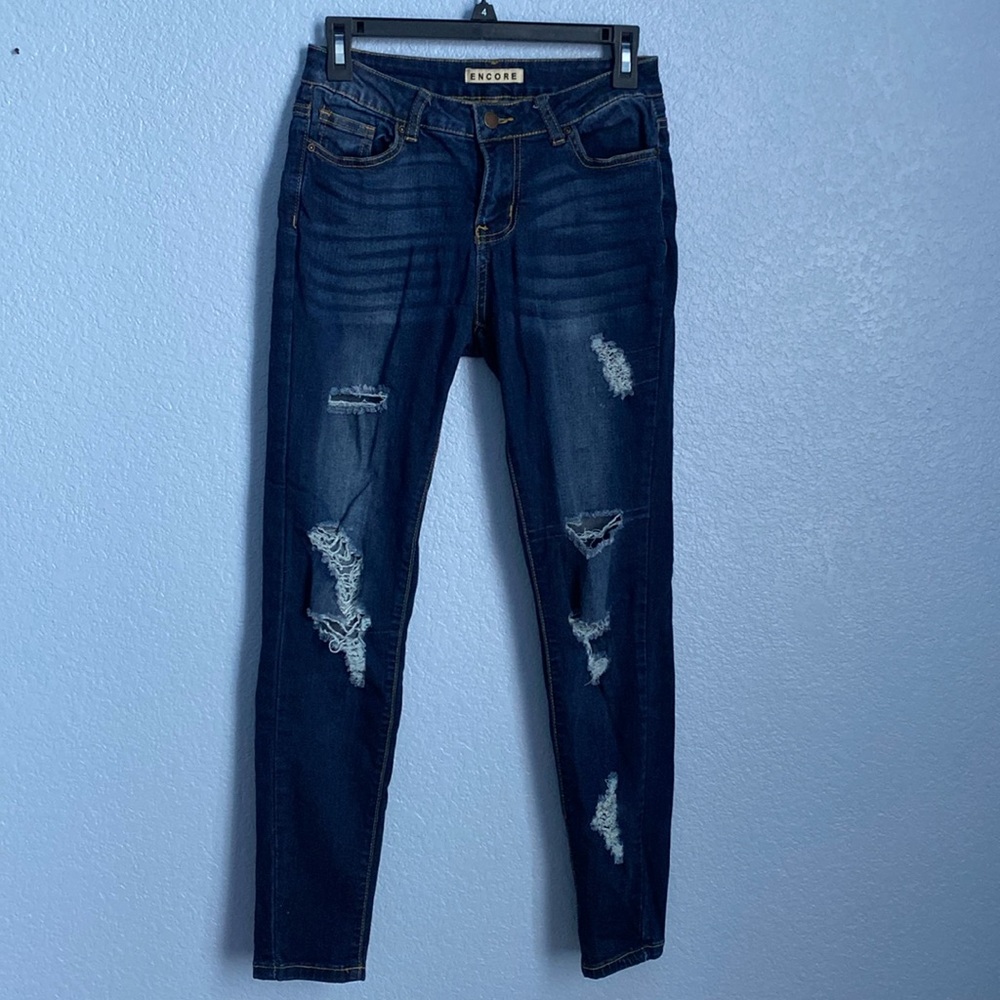 Ripped blue jeans. Barely worn. Size 2-4